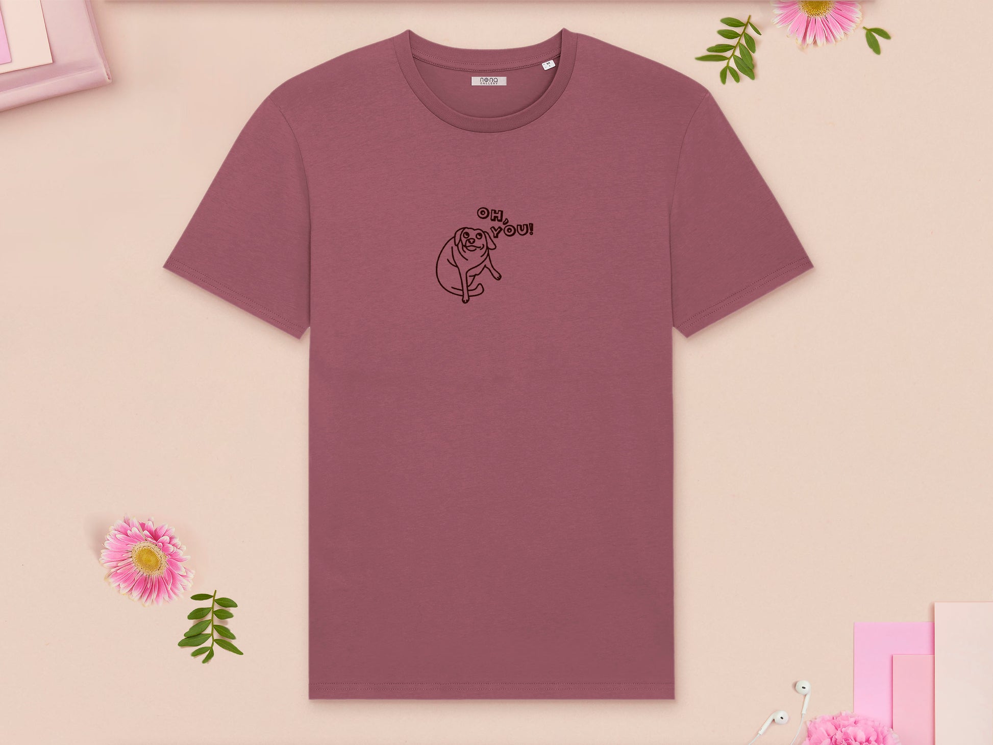 A red crew neck short sleeve t-shirt, with an embroidered brown thread design of cute meme dog with cheeky expression and big eyes, with the text Oh You!