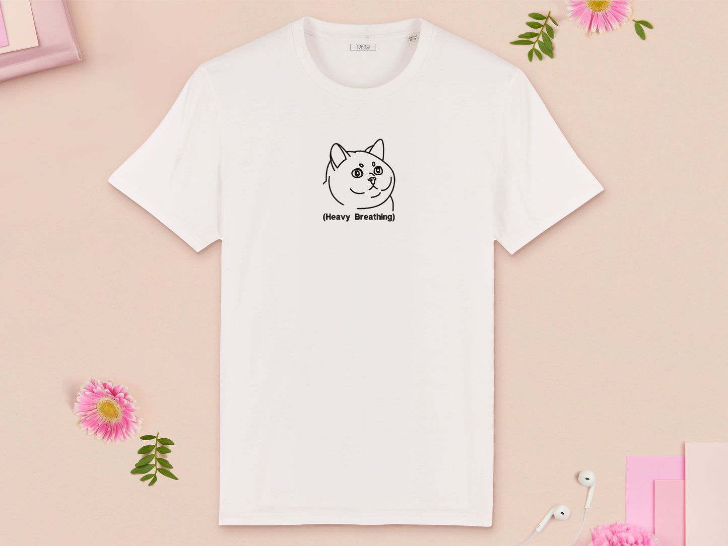A white crew neck short sleeve t-shirt, with an embroidered black thread design of cute fat cat portrait with text underneath saying (Heavy Breathing)